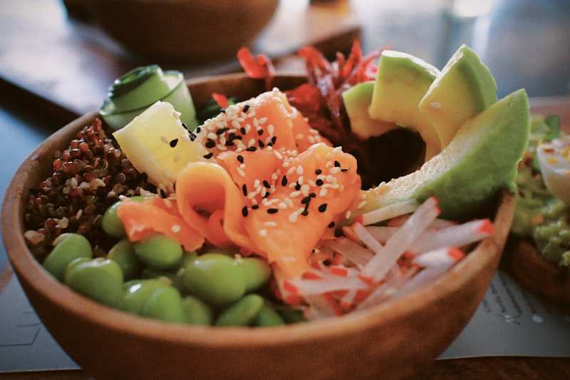 A salmon poke bowl with rice, avocado and edamame