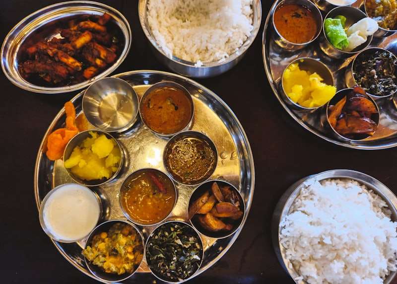 A vegetarian thali: rice, dal, sabzi and rotis on a steel plate